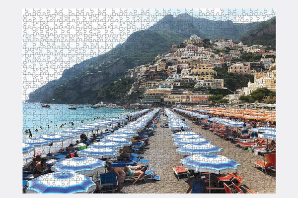 Transport yourself to the stunning Amalfi Coast with this 1000-piece puzzle of Positano, Italy, by Australian artist Hugo Taemets. The puzzle is made with high-quality materials and features a unique cut that makes it both challenging and rewarding to complete. It's the perfect way to relax and unwind after a long day, or to enjoy a fun activity with family and friends.